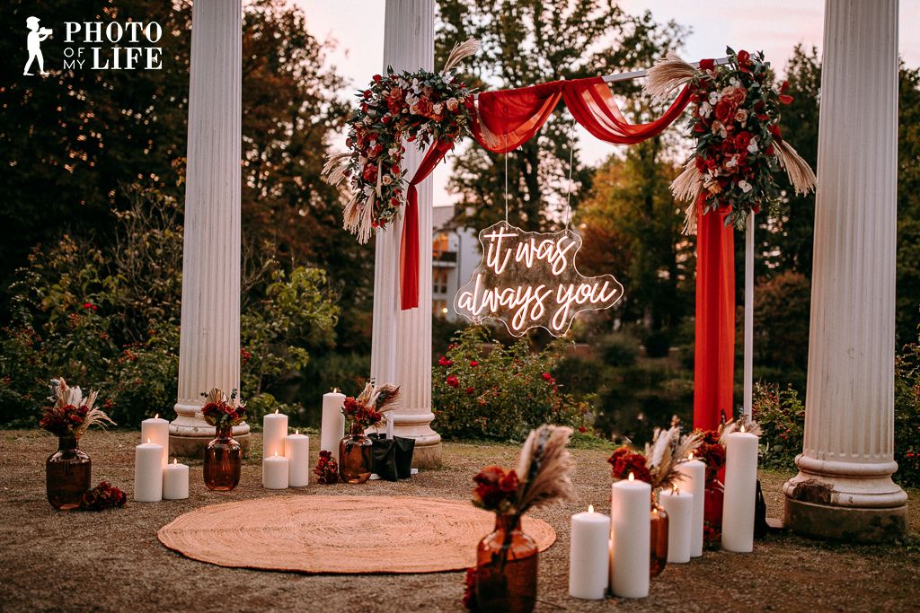 Boho Love proposal decoration with pillars and neon sign reading It Was Always You