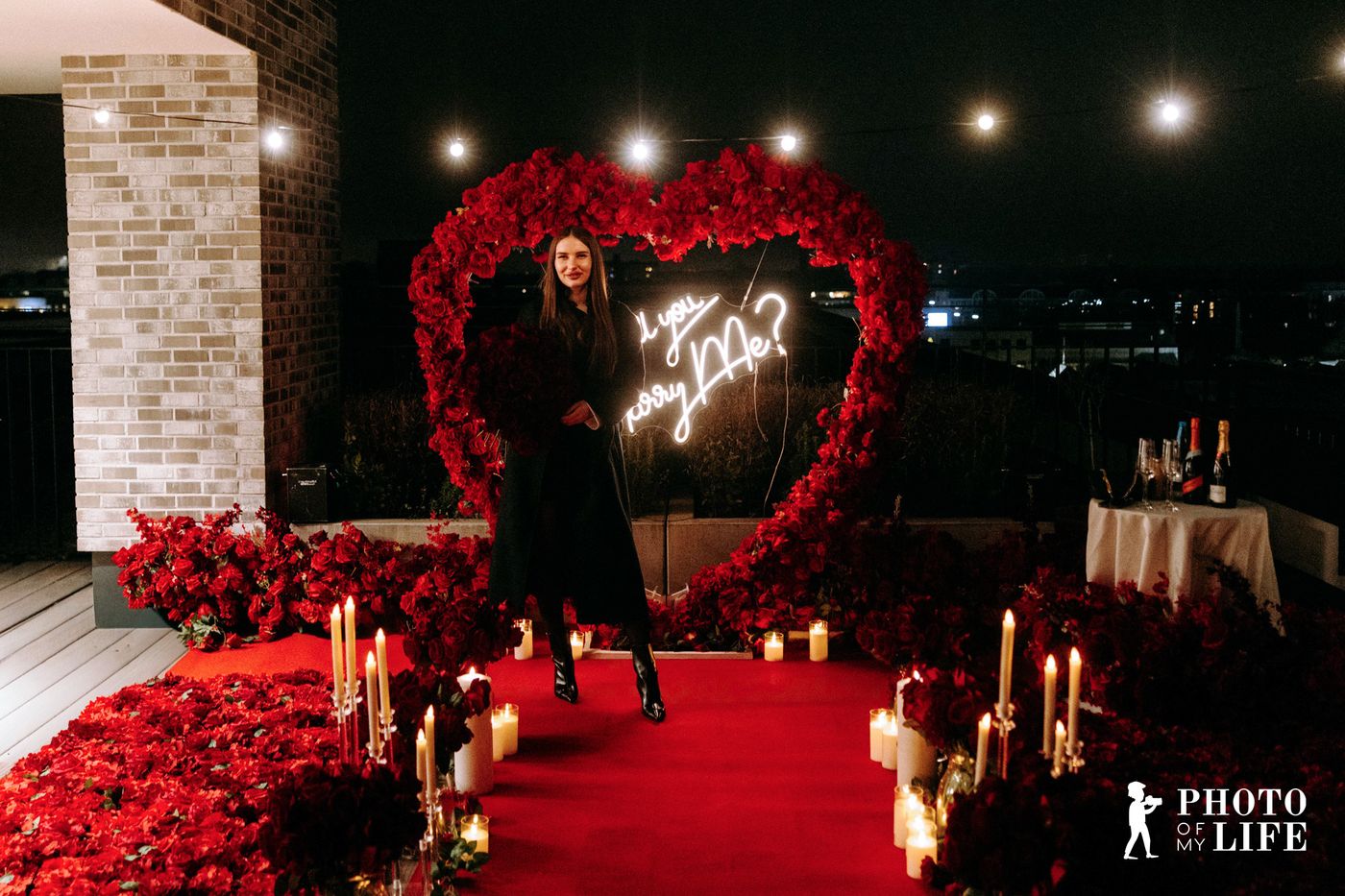 Dream of Roses proposal – large red rose heart with neon sign on rooftop at night