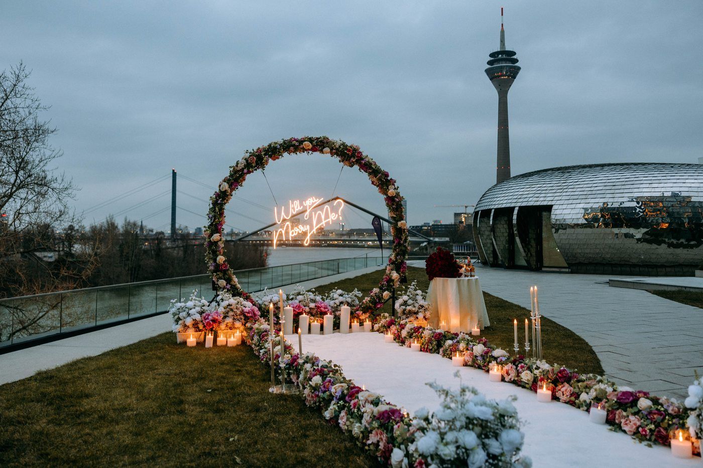 Flower Magic proposal in Düsseldorf at Rhine Tower – flower circle arch with candle path