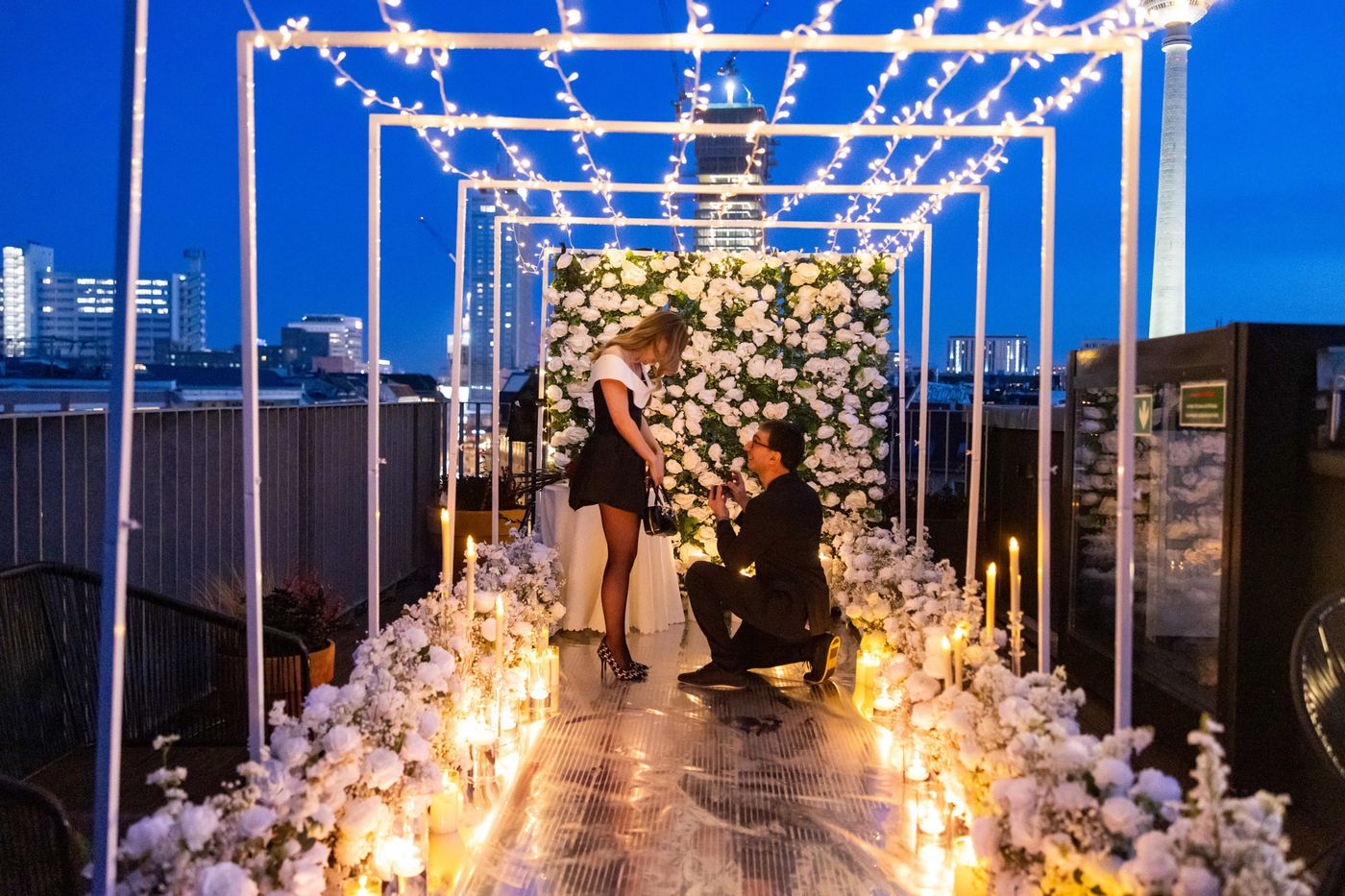 Heaven on Earth proposal in Berlin – fairy lights tunnel with man kneeling for partner