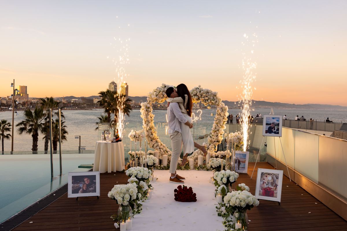 Marriage proposal in Barcelona on rooftop at sunset with Mediterranean sea view