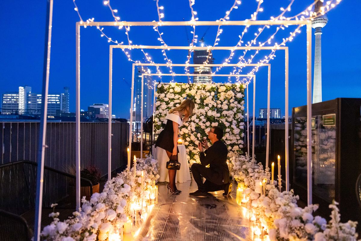 Marriage proposal in Berlin – TV Tower backdrop with fairy lights and white flower wall