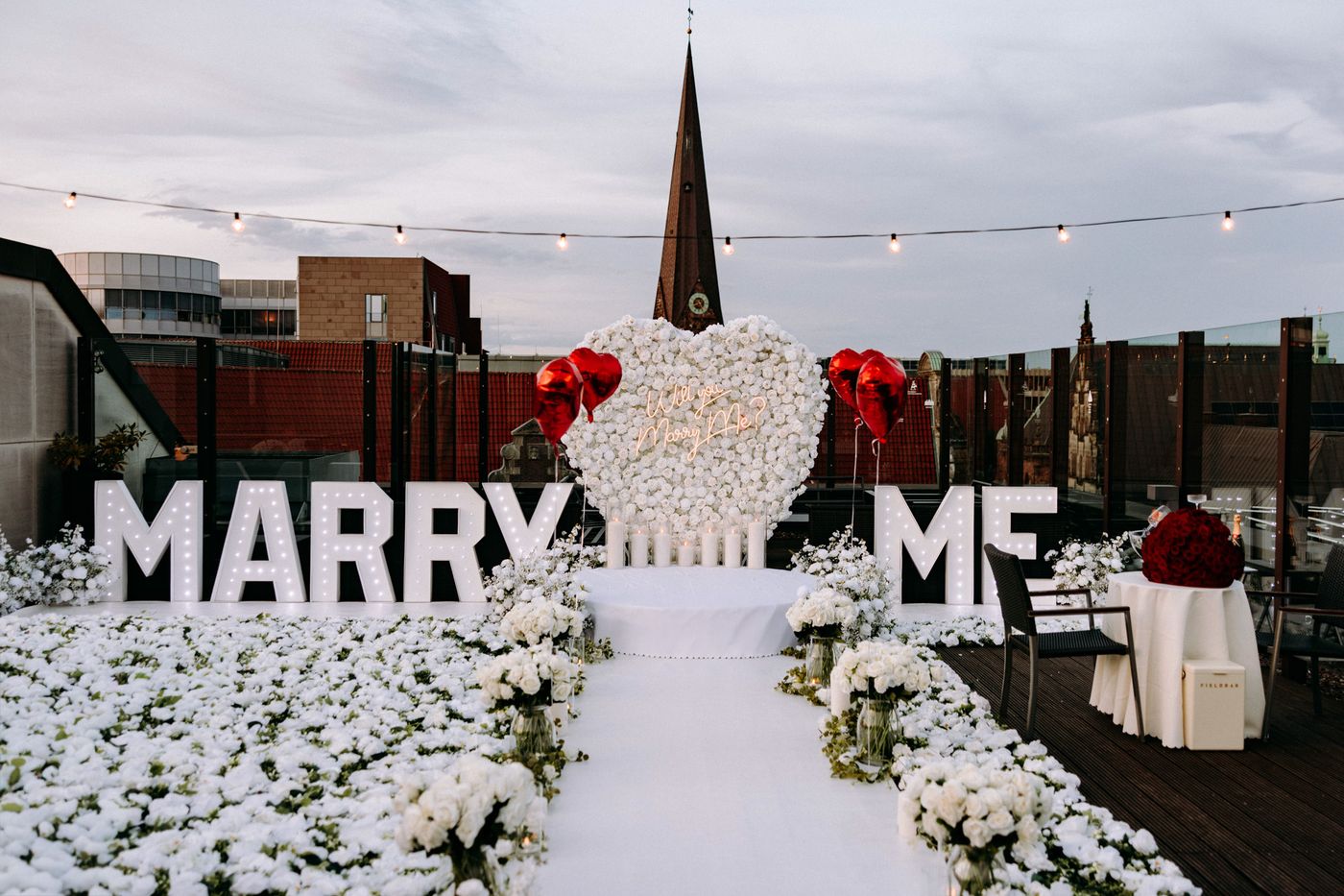 Power of Love proposal decoration – illuminated MARRY ME letters with white balloons