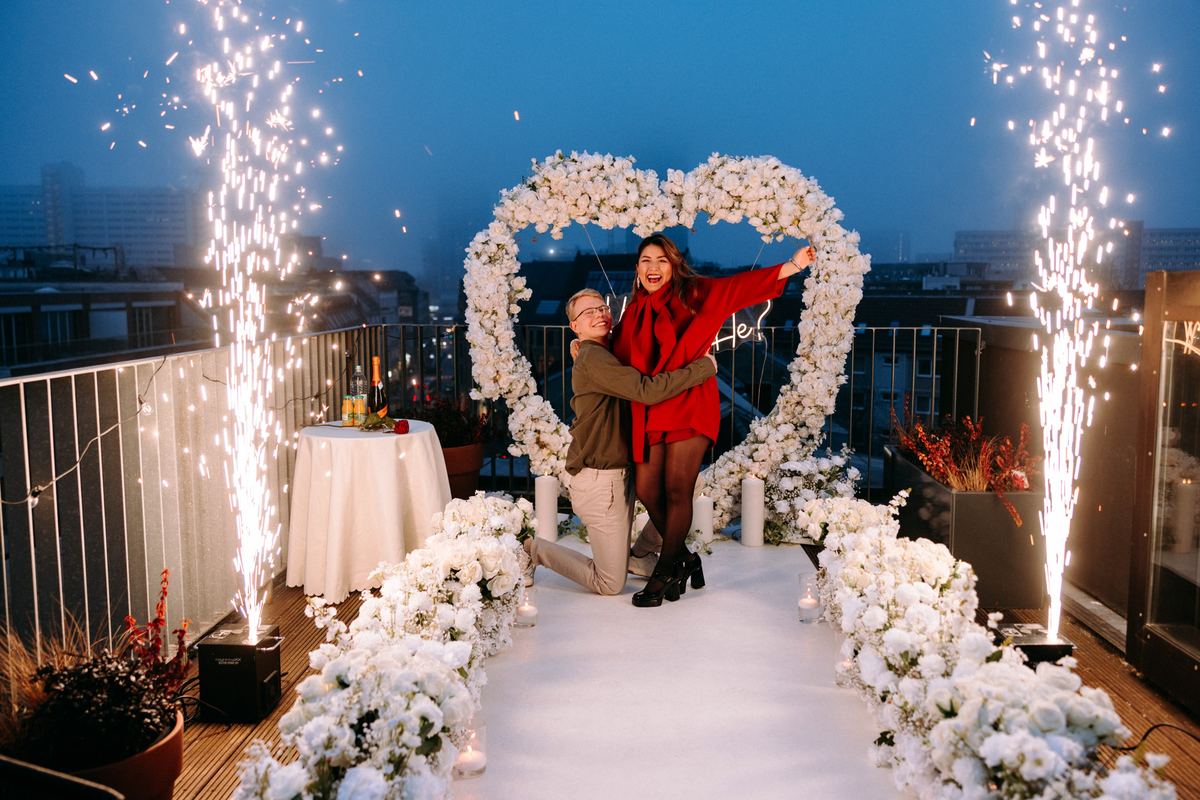 Marriage proposal in Berlin – rooftop white heart with fireworks, man kneeling